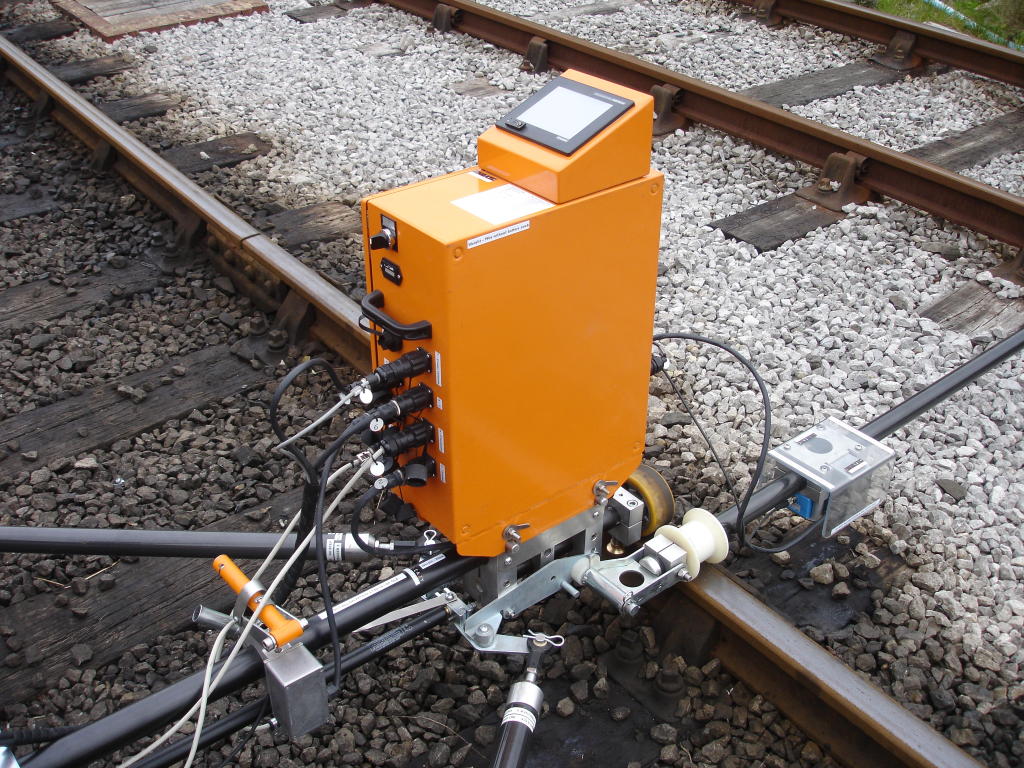 A track mounted Railway Survey Maintenance Machine next to the platform