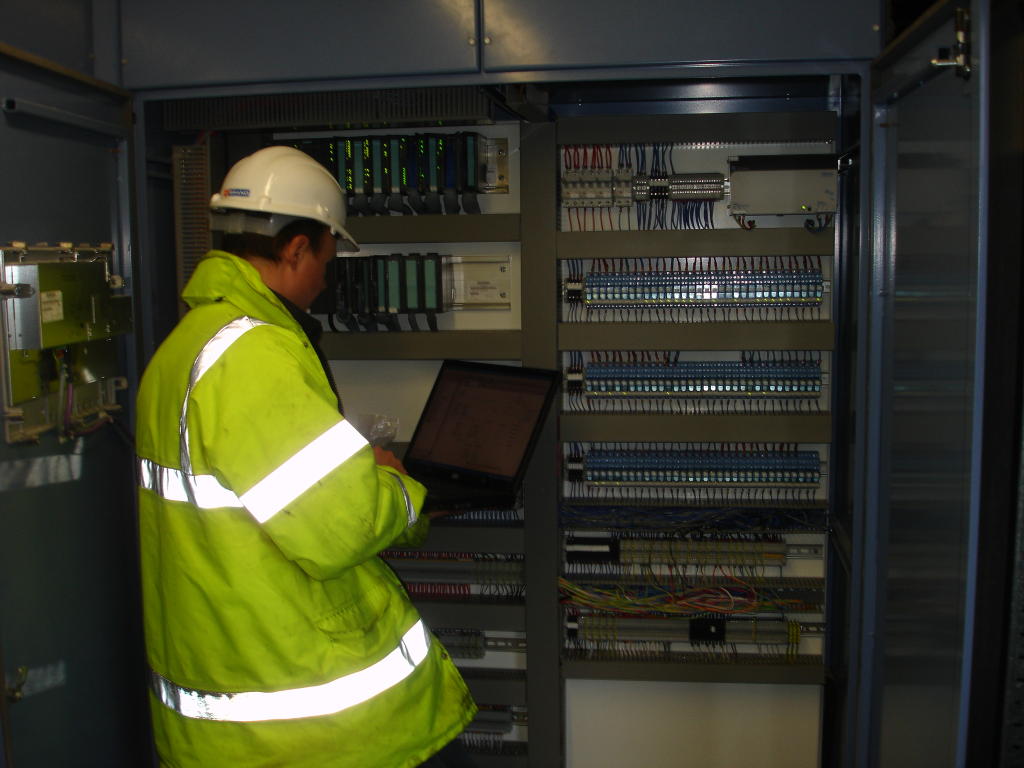 A Freelance PLC Programmer working on a Siemens S7 PLC in a Control Panel