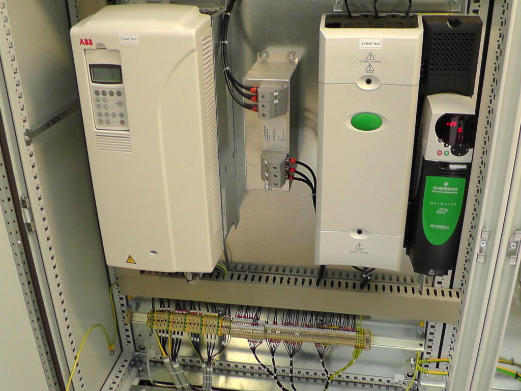 Image showing Emerson and ABB Inverter Drives side by side in a Controls Panel