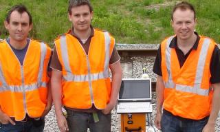 Several Railway Track Survey Engineers Working by a Railway platform